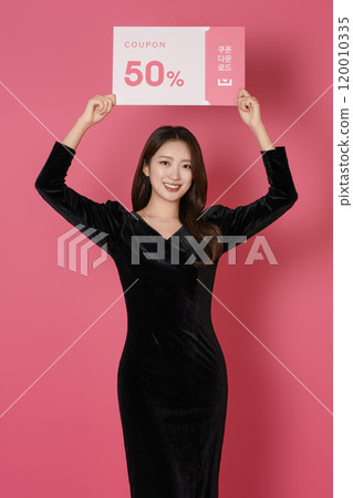A woman in her 20s posing with a 50 percent discount coupon 120010335