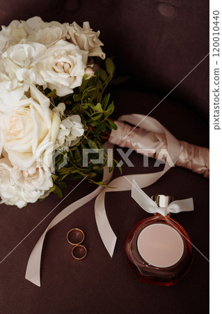 A modern composition of elegant wedding accessories for an attractive bride. A modern composition of elegant wedding accessories for an attractive bride. 120010440