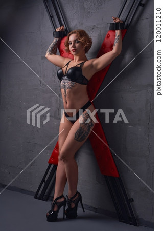 Alluring dominant woman near X cross ready for BDSM game 120011210