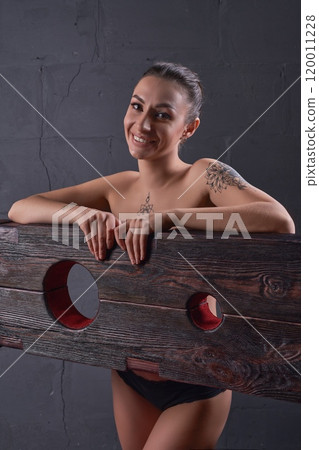 Seductive female in underwear smiles into camera in dark room 120011228