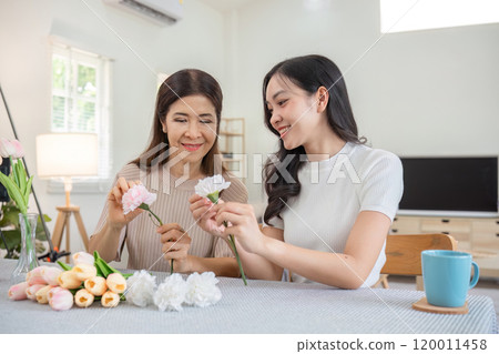Mother and Daughter Bonding While Arranging Beautiful Flowers in a Cozy Home Setting Mother and Daughter Bonding While Arranging Beautiful Flowers in a Cozy Home Setting 120011458