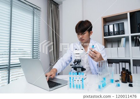 Young Scientist Conducting Innovative Drug Research in a Modern Laboratory Setting with Advanced Equipment 120011476