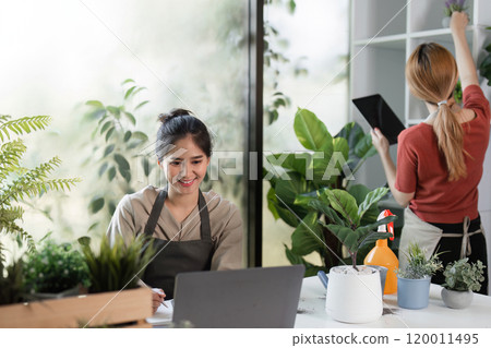 Young Woman Creating Indoor Garden with Houseplants in Modern Room for Sustainable Urban Living and Relaxation Young Woman Creating Indoor Garden with Houseplants in Modern Room for Sustainable Urban Living and Relaxation 120011495