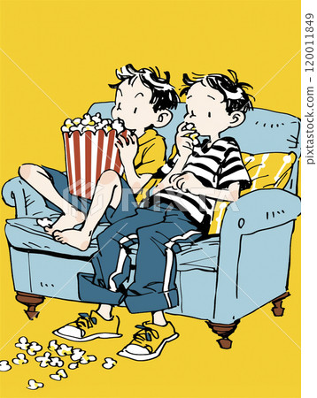 Boys leaning on sofa eating popcorn 120011849