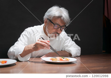 Male chef preparing a dish Male chef preparing a dish 120012098