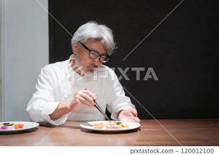 Male chef preparing a dish 120012100