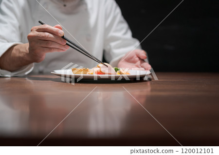 Male chef preparing a dish 120012101