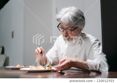 Male chef preparing a dish Male chef preparing a dish 120012503