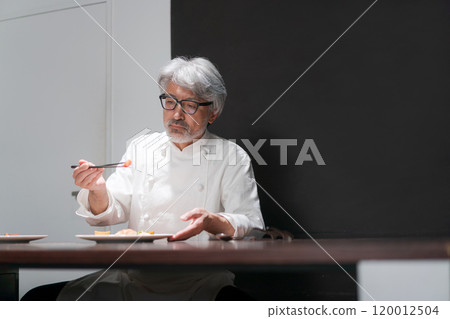 Male chef preparing a dish 120012504