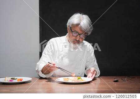 Male chef preparing a dish Male chef preparing a dish 120012505