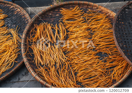 dried fish sticks are dried in sun at a market in Vietnam in Asia 120012709