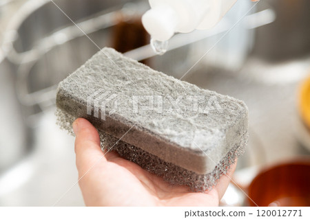 Hands of a middle-aged to senior woman washing dishes in the kitchen 120012771