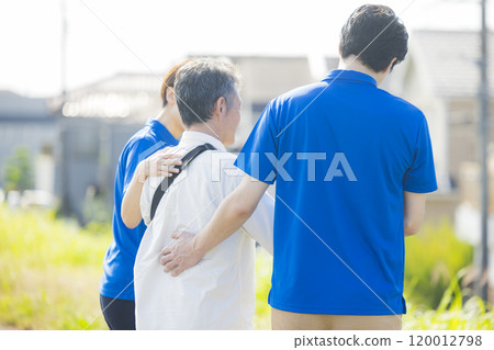 Seniors walking energetically along the bank 120012798