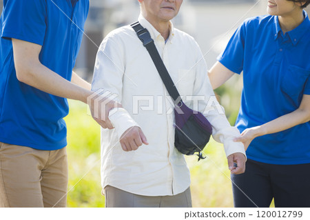 Seniors walking energetically along the bank 120012799