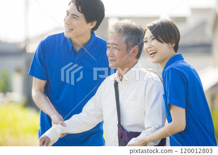 Seniors walking energetically along the bank 120012803