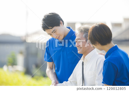 Seniors walking energetically along the bank 120012805