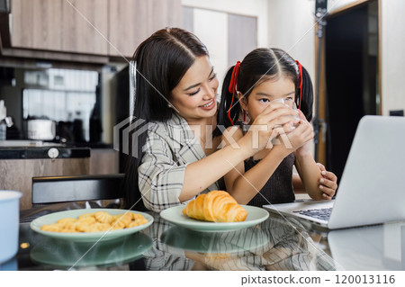business woman work from home and take care of her child while working business woman work from home and take care of her child while working 120013116