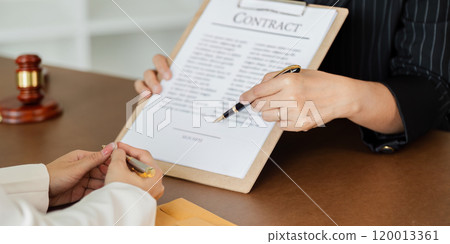 Hand of lawyer pointing at document agreement, contract for businessperson, client signing contract Hand of lawyer pointing at document agreement, contract for businessperson, client signing contract 120013361
