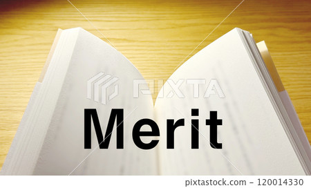 The word Merit written on an open book on a table under a spotlight_wide 120014330
