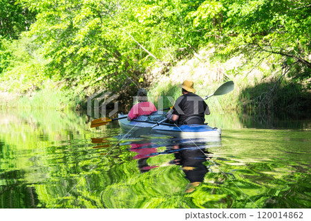 Man and woman couple, in kayak trip rowing boat on the river, water hike, a summer adventure. Eco-friendly and extreme tourism, active and healthy lifestyle 120014862