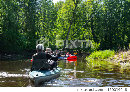 Group kayak trip for seigneur and senora . An elderly couple And adult rowing boat on the river, a water hike, a summer adventure. Age-related sports, mental youth and health, tourism, active old age 120014948