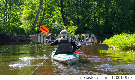 Group kayak trip for seigneur and senora . An elderly couple And adult rowing boat on the river, a water hike, a summer adventure. Age-related sports, mental youth and health, tourism, active old age Group kayak trip for seigneur and senora . An elderly couple And adult rowing boat on the river, a water hike, a summer adventure. Age-related sports, mental youth and health, tourism, active old age 120014950