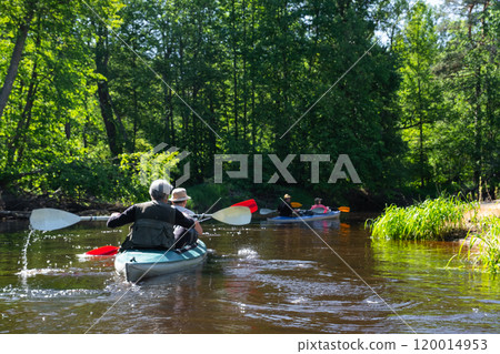 Group kayak trip for seigneur and senora . An elderly couple And adult rowing boat on the river, a water hike, a summer adventure. Age-related sports, mental youth and health, tourism, active old age Group kayak trip for seigneur and senora . An elderly couple And adult rowing boat on the river, a water hike, a summer adventure. Age-related sports, mental youth and health, tourism, active old age 120014953