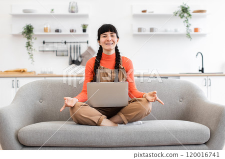 Caucasian woman meditating at home during remote work break 120016741