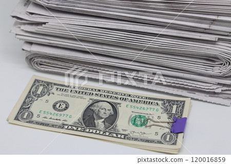 Rolled up stack of newspapers, banknotes stuck between newspapers, news, fake news, corrupt press. Rolled up stack of newspapers, banknotes stuck between newspapers, news, fake news, corrupt press. 120016859
