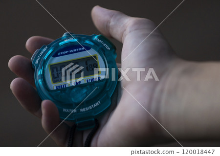 Hand holding a stopwatch Hand holding a stopwatch 120018447