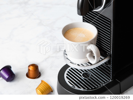 Cup of fresh morning coffee from home coffee machine with espresso pod on white background. Cup of fresh morning coffee from home coffee machine with espresso pod on white background. 120019269