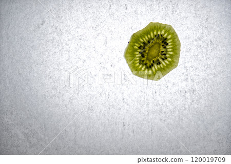 A slice of kiwi fruit with backlight A slice of kiwi fruit with backlight 120019709