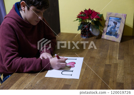 Caucasian boy dedicates a drawing with the words I Love U to the beloved girl Caucasian boy dedicates a drawing with the words I Love U to the beloved girl 120019726