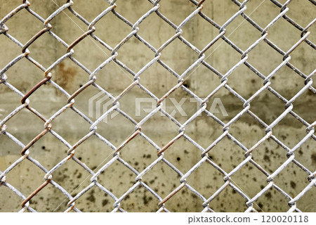 Wire fence with cement wall background. 120020118