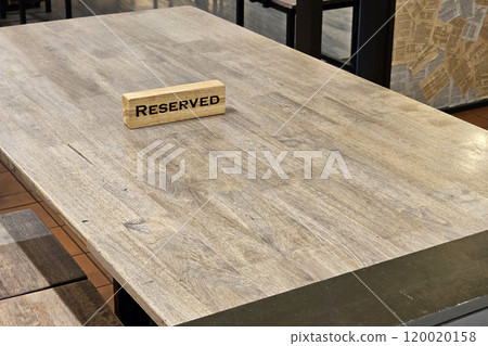 Reserved sign on Wooden Table. 120020158