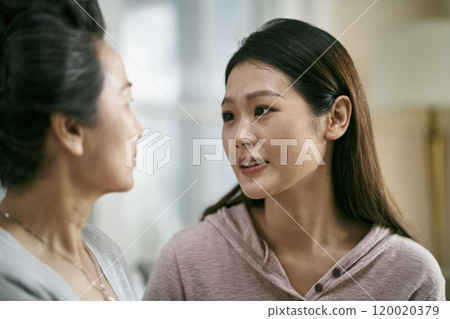 young asian daughter comforting elderly mother 120020379