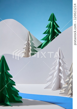 A template picture of the winter concept shows an empty space to display products, surrounded by various pine papers and a river of green paper, behind is a hill of white paper on a blue background. 120021214