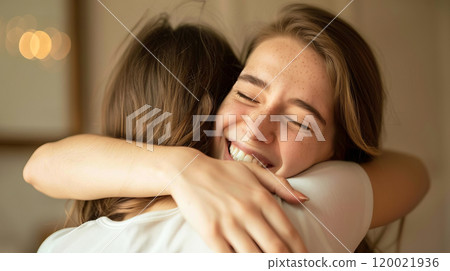 Two Friends Share a Joyful Hug Indoors During a Cozy Gathering on a Weekend Afternoon Two Friends Share a Joyful Hug Indoors During a Cozy Gathering on a Weekend Afternoon 120021936