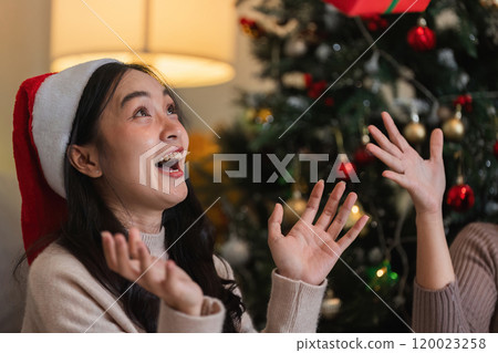 Joyful Lesbian Couple Celebrating Christmas Together with Festive Decorations and Holiday Spirit Joyful Lesbian Couple Celebrating Christmas Together with Festive Decorations and Holiday Spirit 120023258