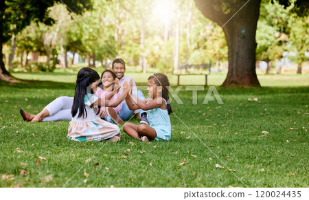 Family, playing and children in nature park, siblings and traditional or hand games on grass on summer break. Parents, relaxing and girls for child development, bonding and fun activity with people 120024435