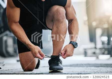 Legs, shoelace and tying in gym, person and closeup of athlete, sportswear and strong with workout. Routine, training and fitness in health club, man and ready for competition in sports and hands 120024523