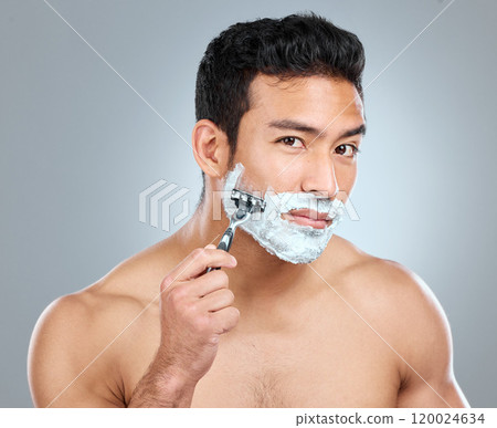 Beauty, shaving and portrait of masculine man in studio on gray background for cosmetic wellness. Dermatology, natural and razor with face of confident person in bathroom for hair removal or hygiene Beauty, shaving and portrait of masculine man in studio on gray background for cosmetic wellness. Dermatology, natural and razor with face of confident person in bathroom for hair removal or hygiene 120024634