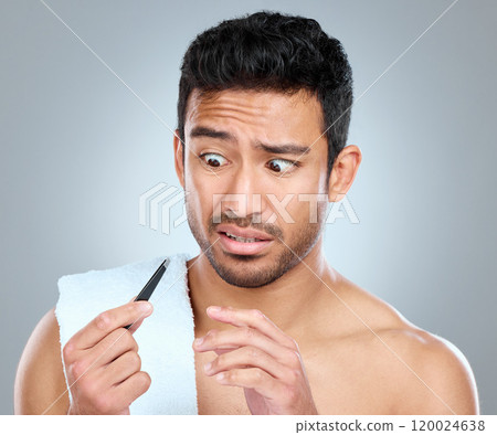 Tweezer, hair removal and confused male person in studio, grooming and cosmetic on white background. Towel, scared emotion and male person for plucking, routine and eyebrow for selfcare cleaning 120024638