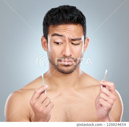 Man, thinking and earbuds for cleaning, selfcare and grooming on white background. Choice, product and plastic or bamboo for option, male person and sustainability for recycling and reduce pollution Man, thinking and earbuds for cleaning, selfcare and grooming on white background. Choice, product and plastic or bamboo for option, male person and sustainability for recycling and reduce pollution 120024654