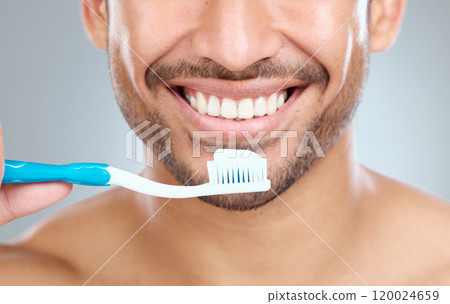 Smile, oral hygiene and toothbrush for man, mouth and studio for dental healthcare on white background. Grooming, closeup or routine with face for person, beauty or toothpaste for fresh breath health Smile, oral hygiene and toothbrush for man, mouth and studio for dental healthcare on white background. Grooming, closeup or routine with face for person, beauty or toothpaste for fresh breath health 120024659