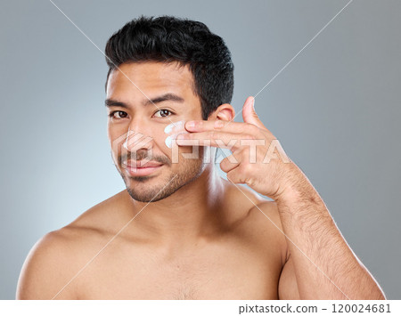 Man, happy and portrait with face cream in studio for skincare, hydration and skin tone with dermatology or cosmetology. Person, lotion and product on gray background for facial care, shine and glow. Man, happy and portrait with face cream in studio for skincare, hydration and skin tone with dermatology or cosmetology. Person, lotion and product on gray background for facial care, shine and glow. 120024681