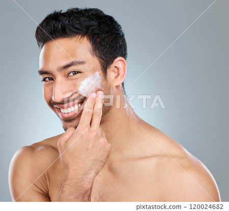 Man, happy and portrait with cream on studio backdrop for skincare, hydration and skin tone with dermatology. Male person, lotion and sunscreen on gray background for facial care, grooming and glow. Man, happy and portrait with cream on studio backdrop for skincare, hydration and skin tone with dermatology. Male person, lotion and sunscreen on gray background for facial care, grooming and glow. 120024682