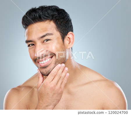 Portrait, skincare and smile of masculine man in studio on gray background for cosmetic wellness. Beauty, dermatology and natural with face of confident person in bathroom for hydration or hygiene Portrait, skincare and smile of masculine man in studio on gray background for cosmetic wellness. Beauty, dermatology and natural with face of confident person in bathroom for hydration or hygiene 120024700
