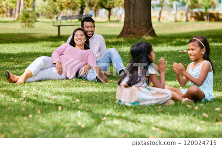 Family, playing and kids in nature park, siblings and traditional or hand games on grass on summer break. Parents, relaxing and girls for child development, bonding and fun activity with people 120024715