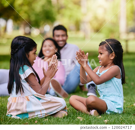 Family, play and children in nature park, siblings and traditional or hand games on grass on summer break. Parents, relaxing and girls for child development, bonding and fun activity with people Family, play and children in nature park, siblings and traditional or hand games on grass on summer break. Parents, relaxing and girls for child development, bonding and fun activity with people 120024717